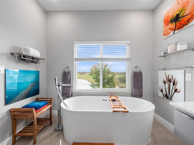 1911 Greenbriar Ter, Davenport, FL 33837 - full bath featuring tile patterned floors, vanity, baseboards, and a soaking tub