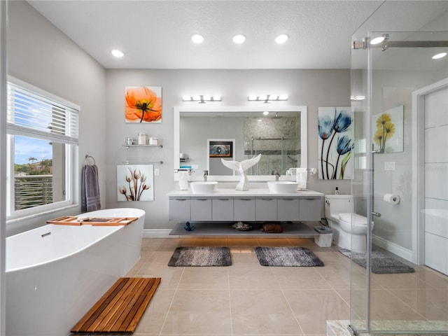 1911 Greenbriar Ter, Davenport, FL 33837 - full bath featuring a sink, a soaking tub, a shower stall, double vanity, and tile patterned flooring