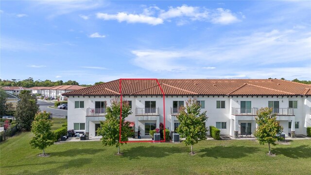 1911 Greenbriar Ter, Davenport, FL 33837 - back of property featuring a lawn, central AC, a tiled roof, and stucco siding
