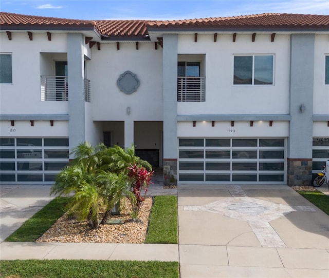 1911 Greenbriar Ter, Davenport, FL 33837 - view of front of house with a tile roof, stucco siding, a garage, and concrete driveway