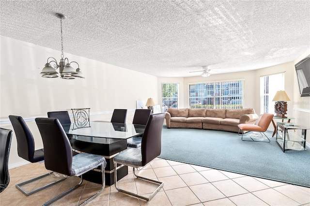 2741 N Poinciana Blvd Unit 49, Kissimmee, FL 34746 - dining space with light tile patterned flooring, ceiling fan with notable chandelier, a textured ceiling, and a wealth of natural light