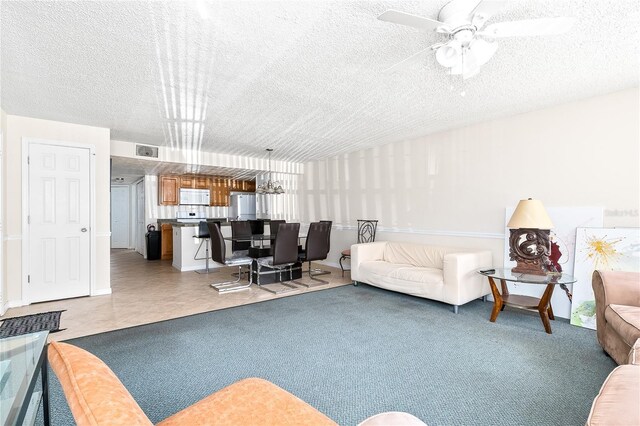 2741 N Poinciana Blvd Unit 49, Kissimmee, FL 34746 - living area with light colored carpet, visible vents, ceiling fan, and a textured ceiling