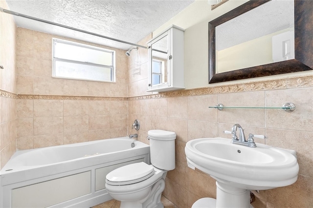 2741 N Poinciana Blvd Unit 49, Kissimmee, FL 34746 - bathroom featuring toilet, shower / washtub combination, a textured ceiling, wainscoting, and tile walls