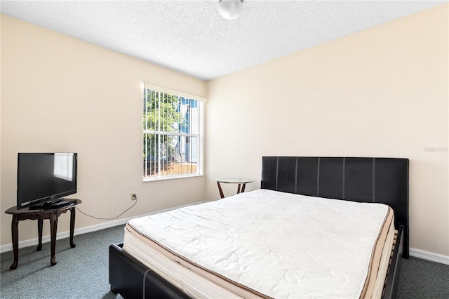 2741 N Poinciana Blvd Unit 49, Kissimmee, FL 34746 - bedroom with baseboards, dark colored carpet, and a textured ceiling