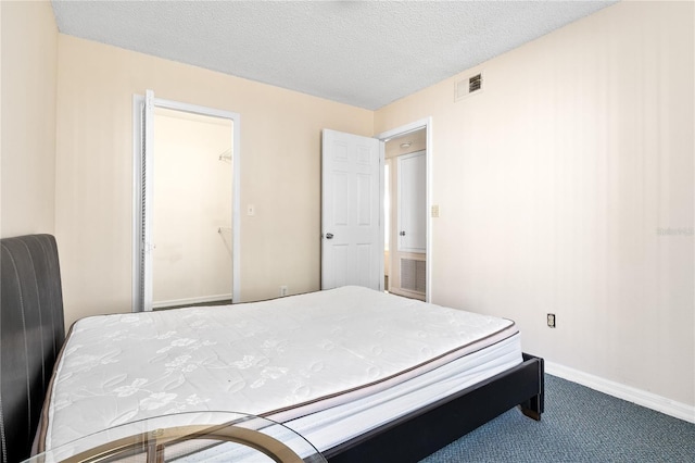 2741 N Poinciana Blvd Unit 49, Kissimmee, FL 34746 - carpeted bedroom featuring baseboards, a textured ceiling, and visible vents