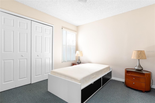 2741 N Poinciana Blvd Unit 49, Kissimmee, FL 34746 - carpeted bedroom featuring a closet, a textured ceiling, and baseboards