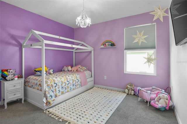 carpeted bedroom featuring baseboards and a chandelier