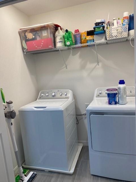 laundry area with washer and dryer, baseboards, and laundry area