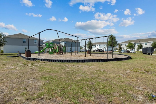 communal playground with a lawn and a residential view
