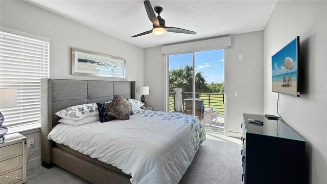 bedroom featuring carpet, a ceiling fan, access to exterior, and a textured ceiling