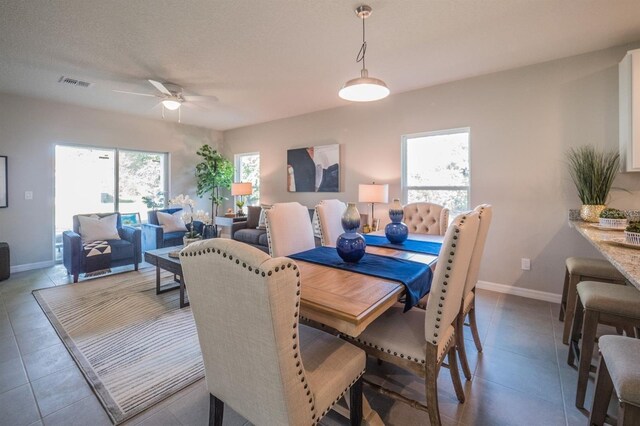 848 San Pedro Ct, Kissimmee, FL 34758 - dining space featuring ceiling fan, a textured ceiling, visible vents, tile patterned floors, and baseboards