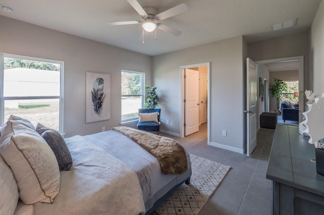 848 San Pedro Ct, Kissimmee, FL 34758 - bedroom featuring visible vents, dark tile patterned floors, ceiling fan, and baseboards