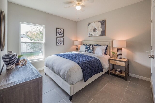 848 San Pedro Ct, Kissimmee, FL 34758 - tiled bedroom featuring baseboards and a ceiling fan