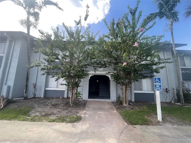4745 S Texas Ave Unit A, Orlando, FL 32839 - view of property hidden behind natural elements featuring stucco siding