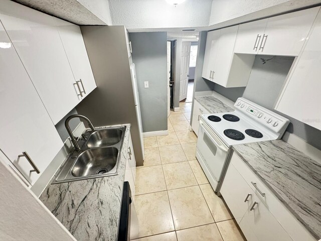 4745 S Texas Ave Unit A, Orlando, FL 32839 - kitchen featuring electric stove, a sink, white cabinetry, light tile patterned floors, and baseboards
