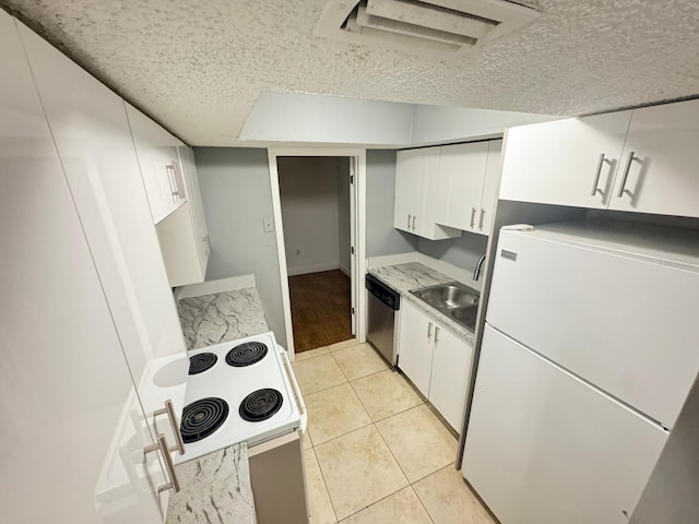 4745 S Texas Ave Unit A, Orlando, FL 32839 - kitchen with freestanding refrigerator, a sink, dishwasher, range, and white cabinetry