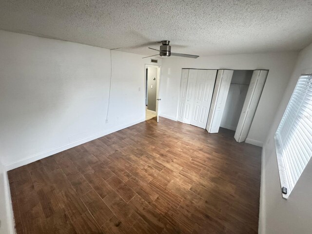 4745 S Texas Ave Unit A, Orlando, FL 32839 - unfurnished bedroom featuring a textured ceiling, a ceiling fan, wood finished floors, baseboards, and a closet