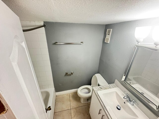 4745 S Texas Ave Unit A, Orlando, FL 32839 - bathroom featuring a textured ceiling, toilet, vanity, tile patterned floors, and shower / bathtub combination