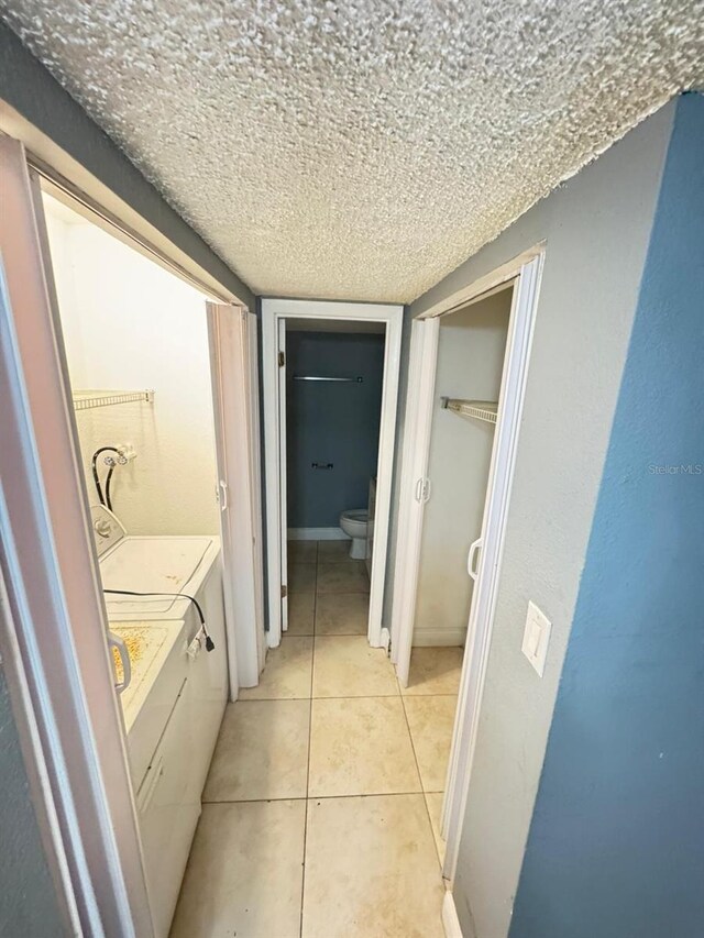 4745 S Texas Ave Unit A, Orlando, FL 32839 - bathroom featuring toilet, washing machine and clothes dryer, vanity, tile patterned flooring, and a textured ceiling