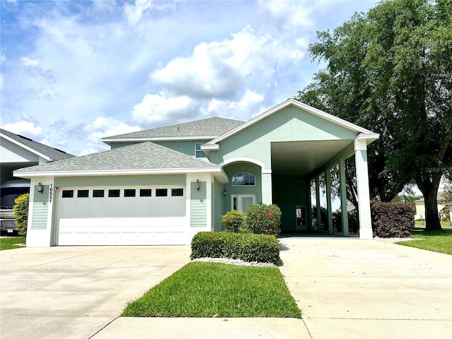 view of front of home featuring an attached garage, a shingled roof, driveway, and stucco siding