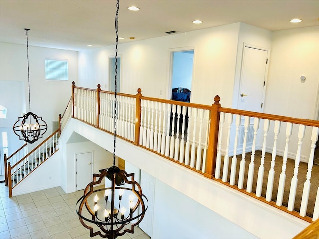 hallway with visible vents, recessed lighting, a chandelier, and tile patterned flooring