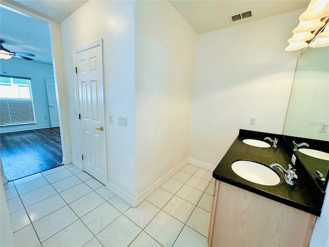 bathroom featuring tile patterned flooring, visible vents, and a sink