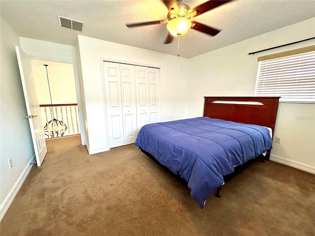 bedroom with visible vents, baseboards, a closet, a ceiling fan, and carpet floors