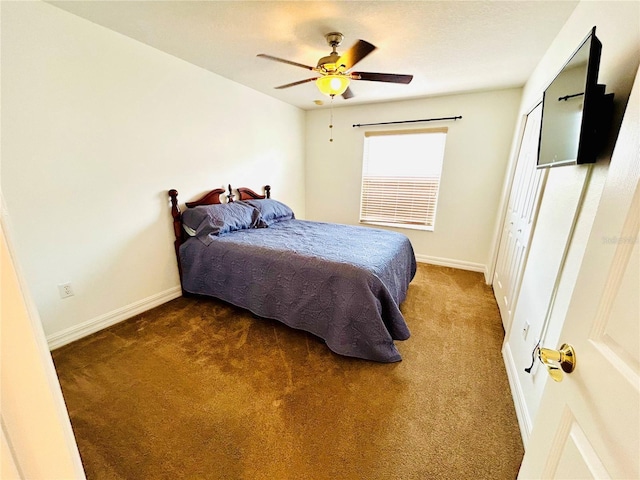 carpeted bedroom with baseboards and a ceiling fan