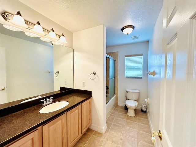 bathroom featuring visible vents, toilet, a textured ceiling, vanity, and tile patterned floors