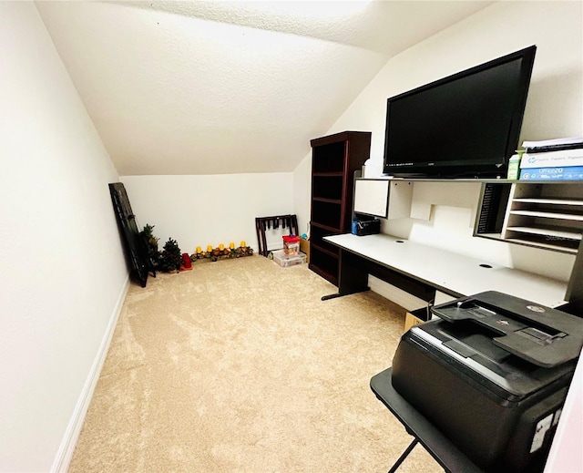 carpeted office with baseboards, vaulted ceiling, and a textured ceiling