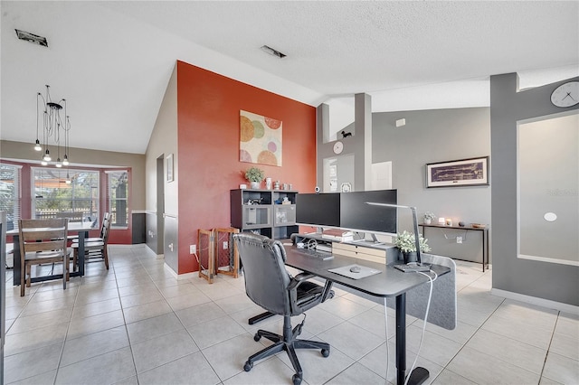 home office with a textured ceiling, light tile patterned floors, baseboards, and vaulted ceiling