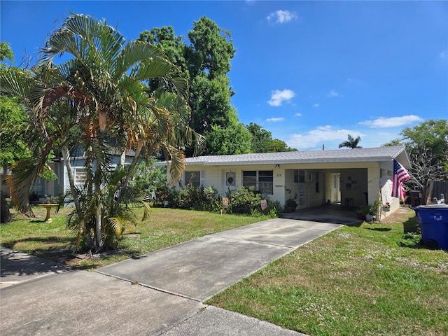 519 New York Ave, Saint Cloud, FL 34769 - view of front facade with a carport, a front lawn, and driveway