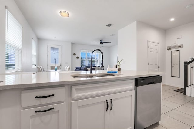 2412 Good Will Aly, Kissimmee, FL 34744 - kitchen featuring stainless steel dishwasher, light tile patterned floors, white cabinets, visible vents, and a sink