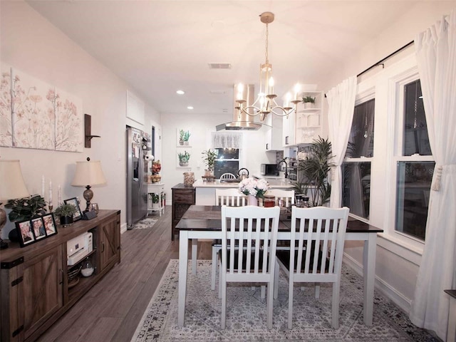 dining room featuring dark wood-style flooring, visible vents, recessed lighting, and a notable chandelier
