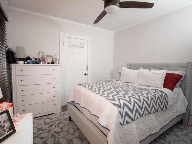 bedroom featuring ornamental molding, a ceiling fan, and carpet flooring
