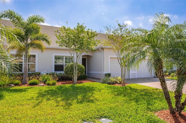view of front facade with stucco siding, decorative driveway, an attached garage, and a front lawn