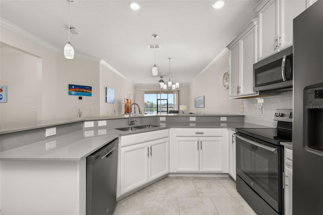 kitchen featuring hanging light fixtures, a sink, crown molding, stainless steel appliances, and backsplash
