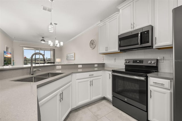 kitchen featuring range with electric cooktop, crown molding, stainless steel microwave, and a sink