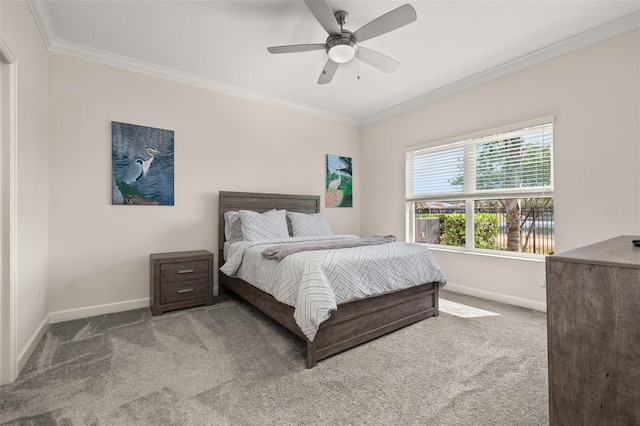 bedroom featuring crown molding, baseboards, and carpet floors