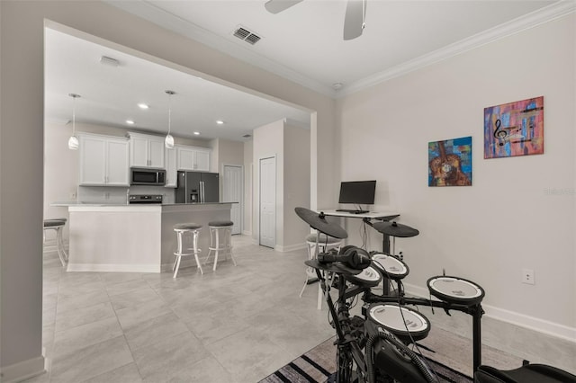 interior space with a ceiling fan, baseboards, ornamental molding, and visible vents