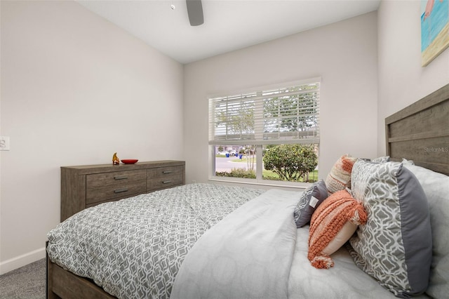 bedroom with ceiling fan, carpet flooring, and baseboards