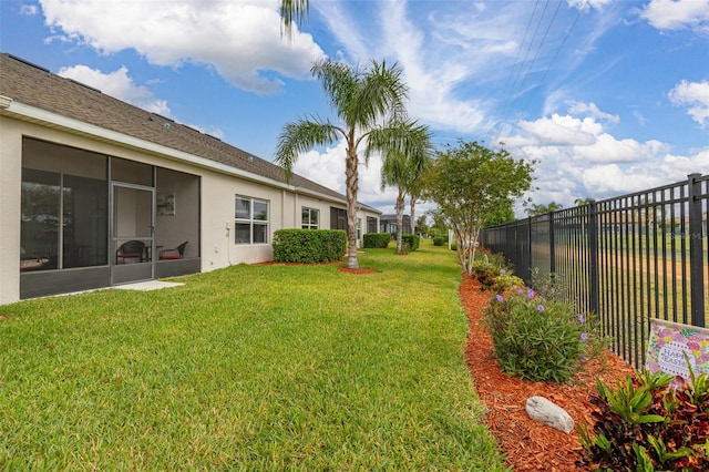 view of yard featuring fence and a sunroom