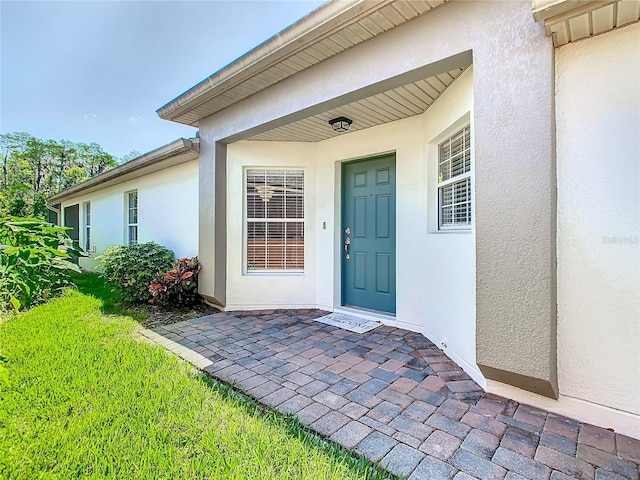 524 Grand Canal Dr, Poinciana, FL 34759 - doorway to property featuring stucco siding