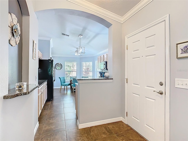 524 Grand Canal Dr, Poinciana, FL 34759 - kitchen with ornamental molding, visible vents, freestanding refrigerator, and white cabinetry