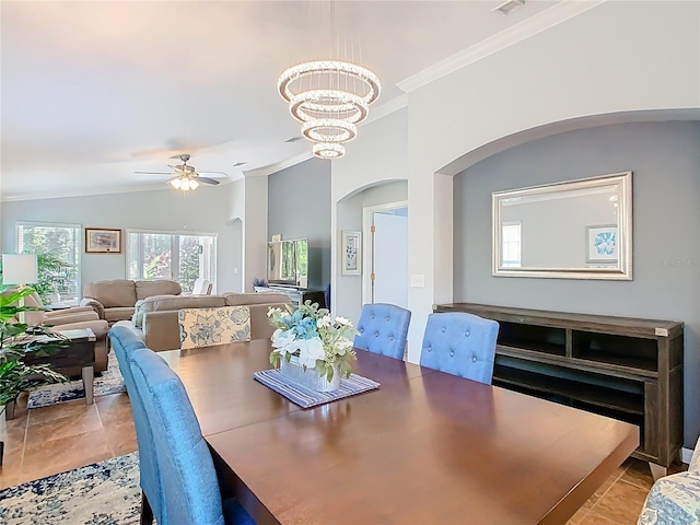 524 Grand Canal Dr, Poinciana, FL 34759 - dining room featuring arched walkways, ceiling fan with notable chandelier, vaulted ceiling, and ornamental molding