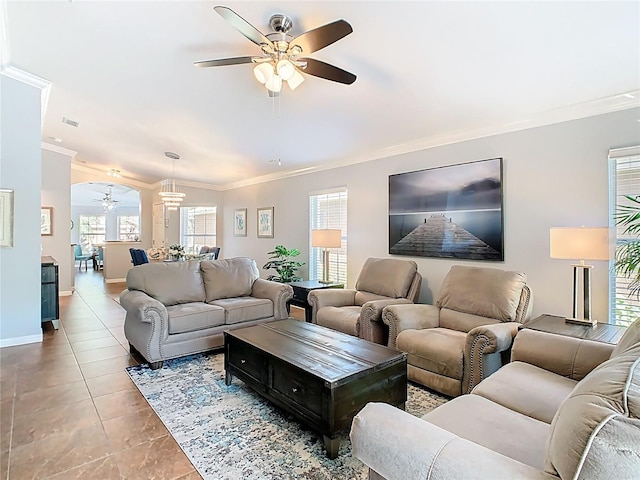524 Grand Canal Dr, Poinciana, FL 34759 - tiled living room with ceiling fan with notable chandelier and ornamental molding