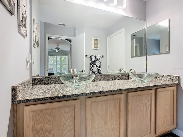 524 Grand Canal Dr, Poinciana, FL 34759 - bathroom featuring double vanity, a sink, a ceiling fan, and visible vents
