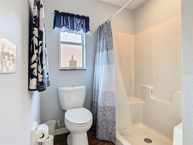 524 Grand Canal Dr, Poinciana, FL 34759 - bathroom featuring toilet, a stall shower, and baseboards