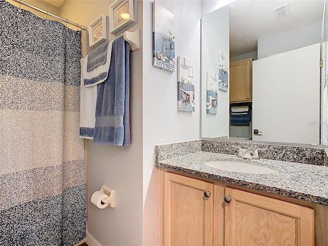 524 Grand Canal Dr, Poinciana, FL 34759 - bathroom featuring curtained shower, vanity, baseboards, and visible vents