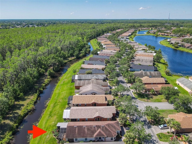 524 Grand Canal Dr, Poinciana, FL 34759 - drone / aerial view featuring a water view, a residential view, and a wooded view